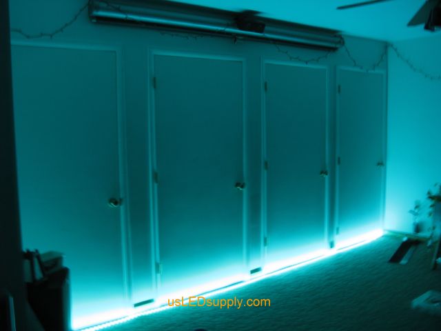 RGB LED strips light up a home theater area in an apartment.