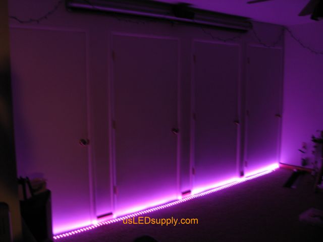 RGB LED strips light up a home theater area in an apartment.