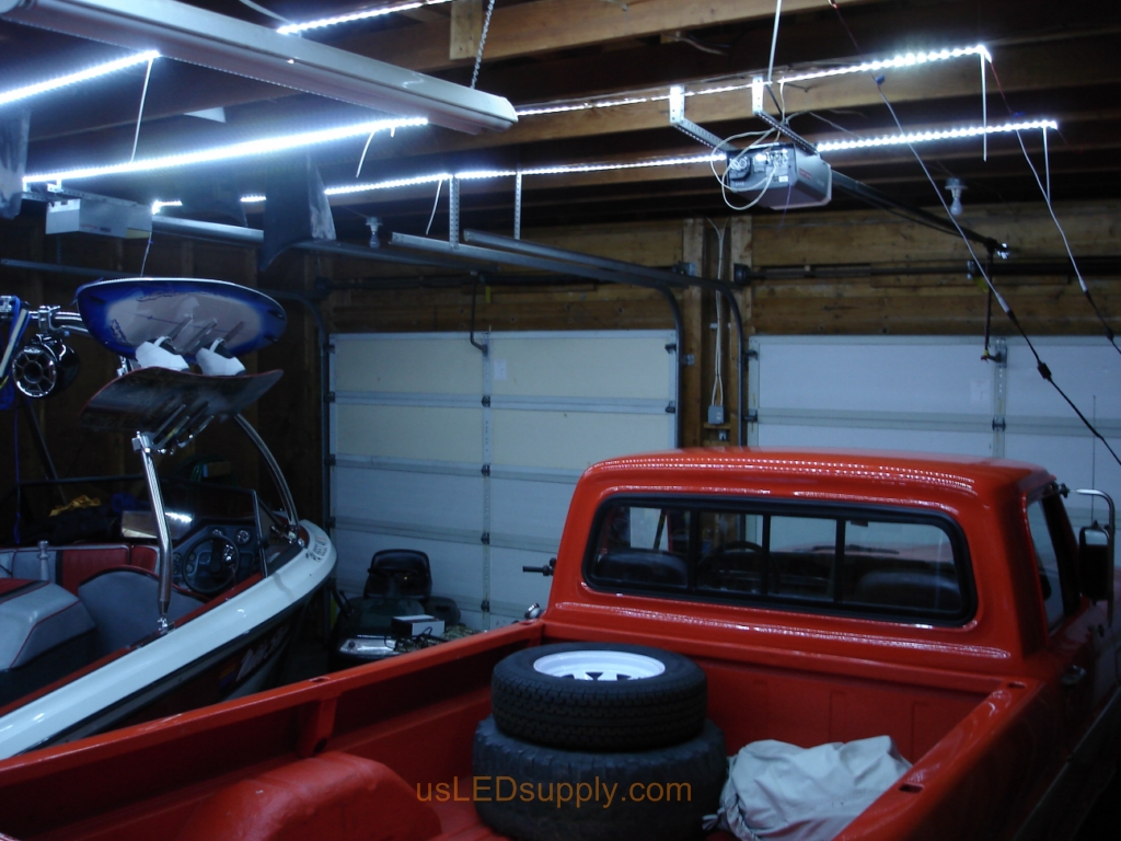 Garage with cool white flexible LED strips installed across beams.