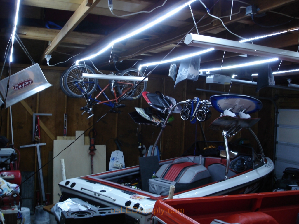 Garage with cool white flexible LED strips installed across beams.