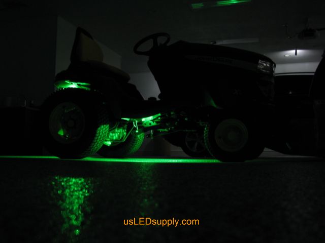 John Deere Tractor with green LED Modules lighting up the ground.