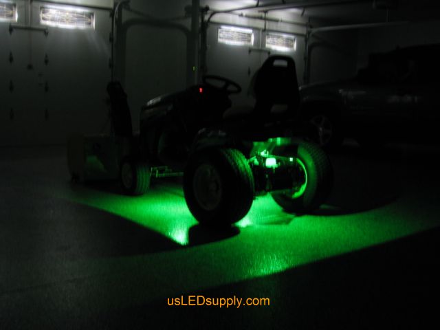 John Deere Tractor with green LED Modules lighting up the ground.