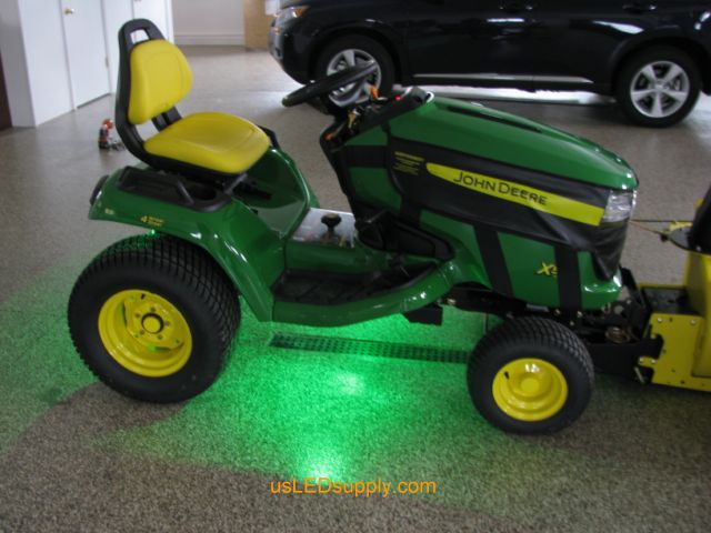 John Deere Tractor with green LED Modules lighting up the ground.