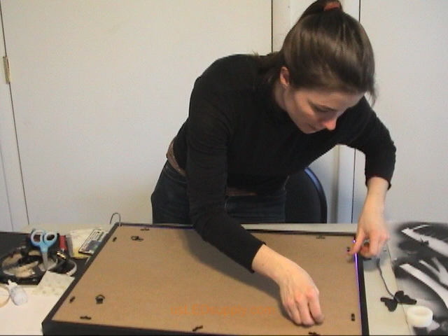 Closing the back of the poster frame.