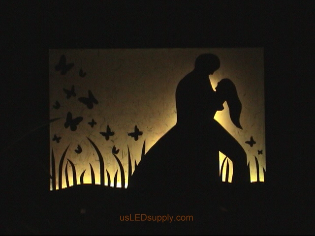RGB LED silhouette art project with couple in love set on white color.
