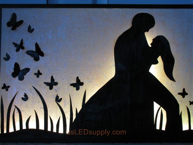 RGB LED silhouette art project with couple in love set on white color.