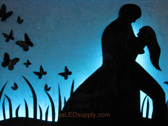 RGB LED silhouette art project with couple in love set on light blue color.