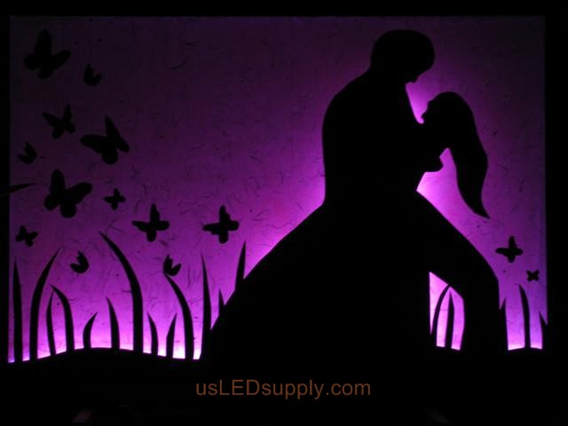 RGB LED silhouette art project with couple in love set on purple color.