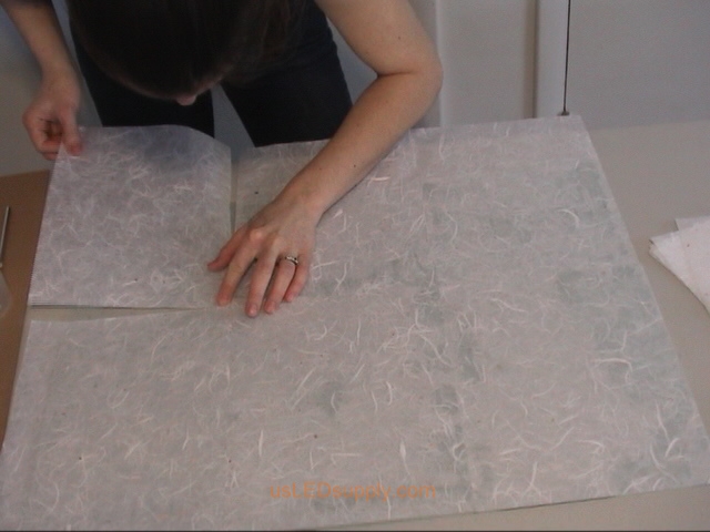 Match up the corners of the paper so that there are no gaps (or buy a larger sheet of paper to cover the entire glass).