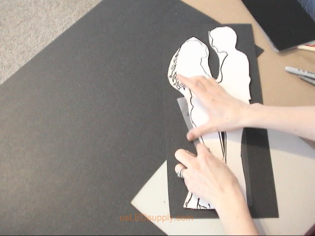 Cut out roughly around the couple and tape it to a piece of medium thickness poster board.