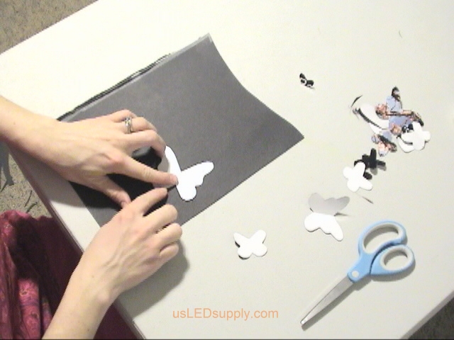 Cutting out different sizes and shapes of butterflies.