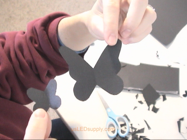 Cutting out different sizes and shapes of butterflies.