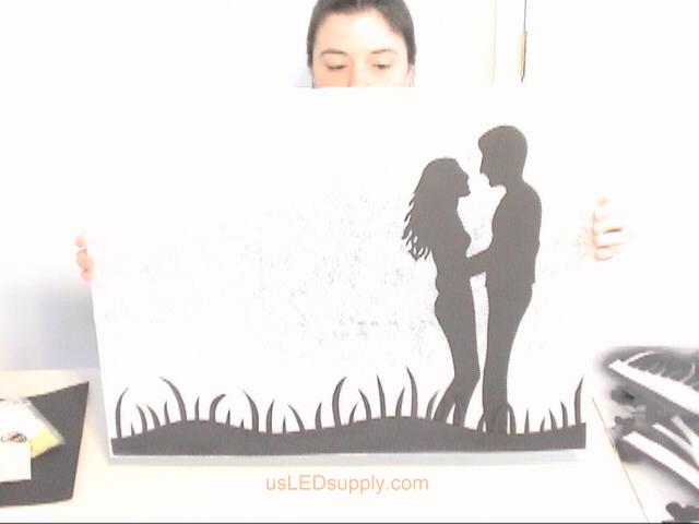 Attach the silhouette pieces to your paper-coated glass with pop up relief glue dots.