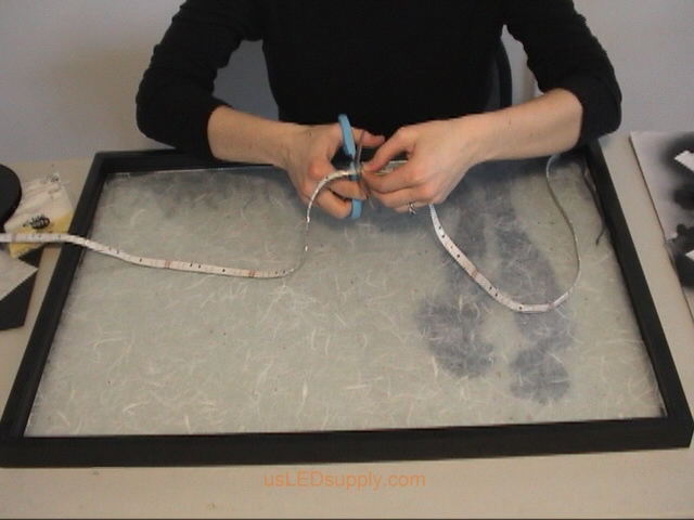 Cutting RGB Flexible LED Strip to light up silhouette art project.