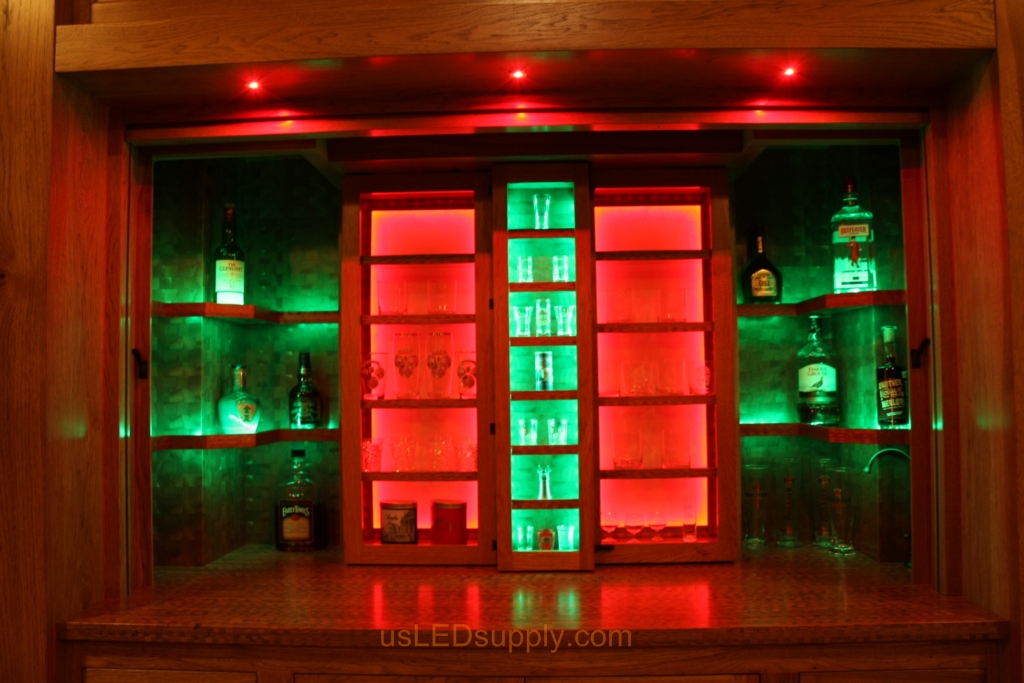 RGB LED Strips in different zones create color effects on this home bar shelving.