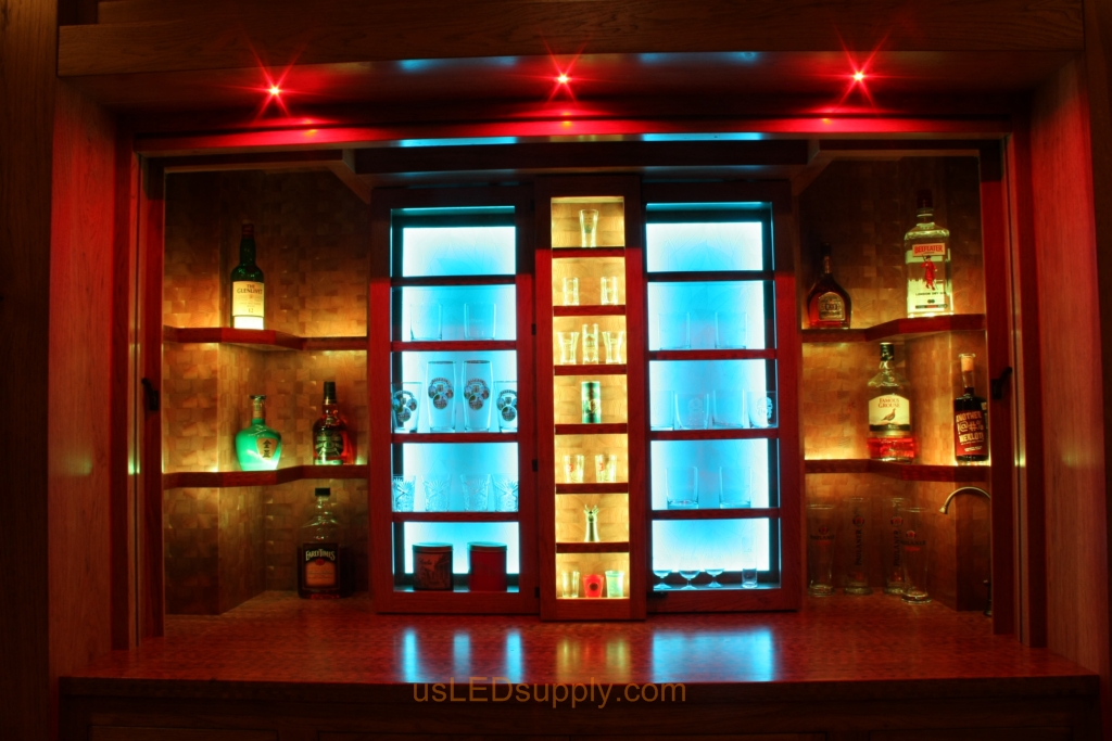 RGB LED Strips in different zones create color effects on this home bar shelving.