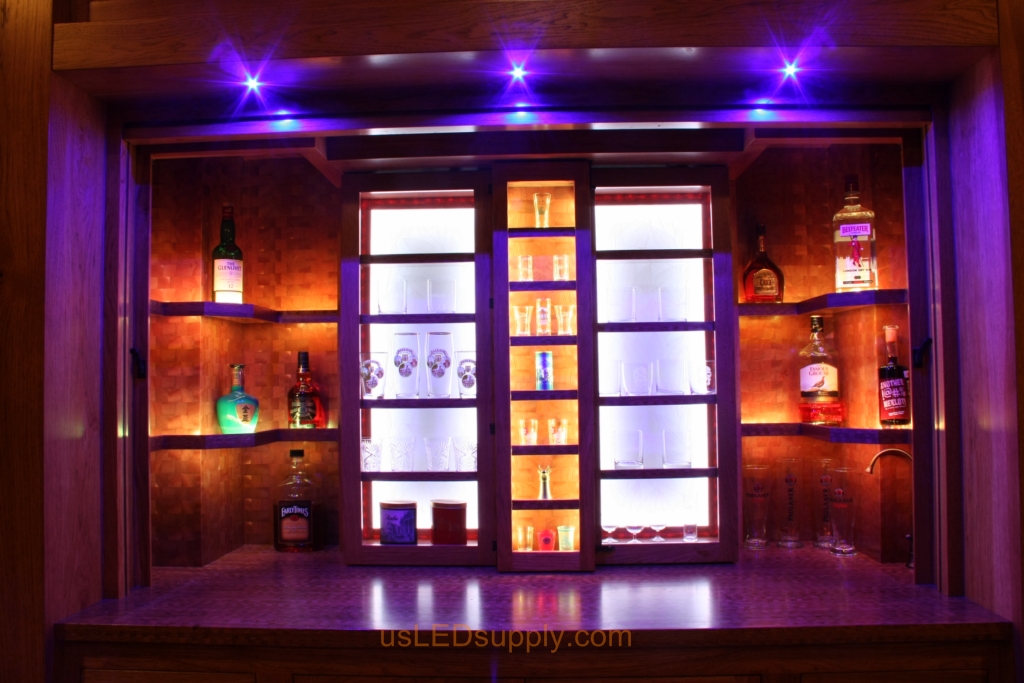 RGB LED Strips in different zones create color effects on this home bar shelving.