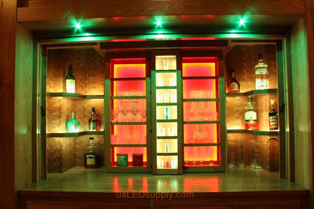 RGB LED Strips in different zones create color effects on this home bar shelving.
