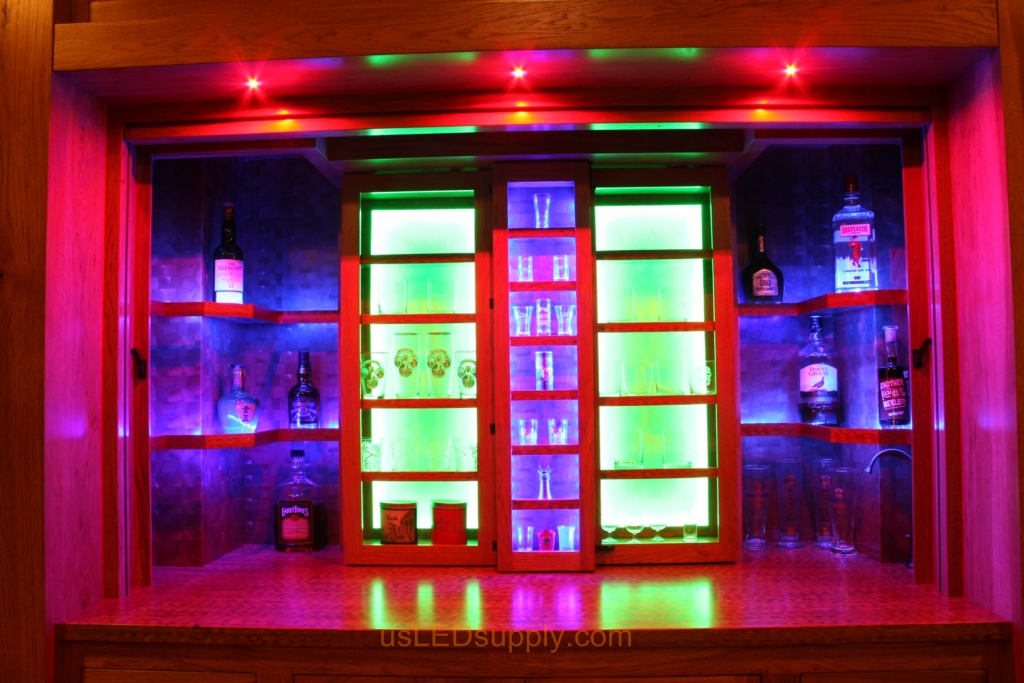 RGB LED Strips in different zones create color effects on this home bar shelving.