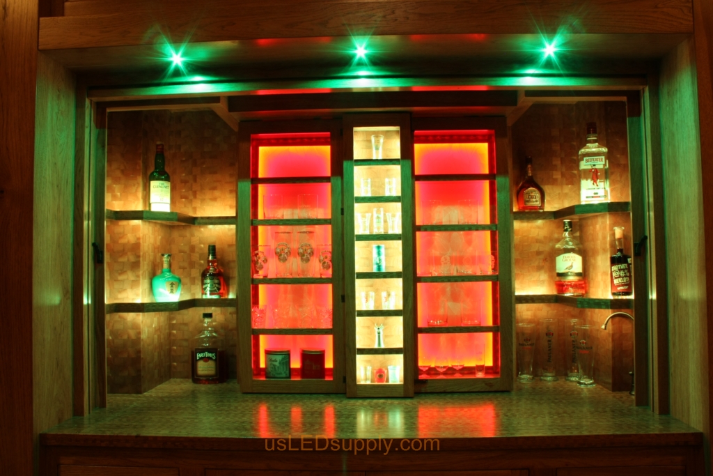 RGB LED Strips in different zones create color effects on this home bar shelving.