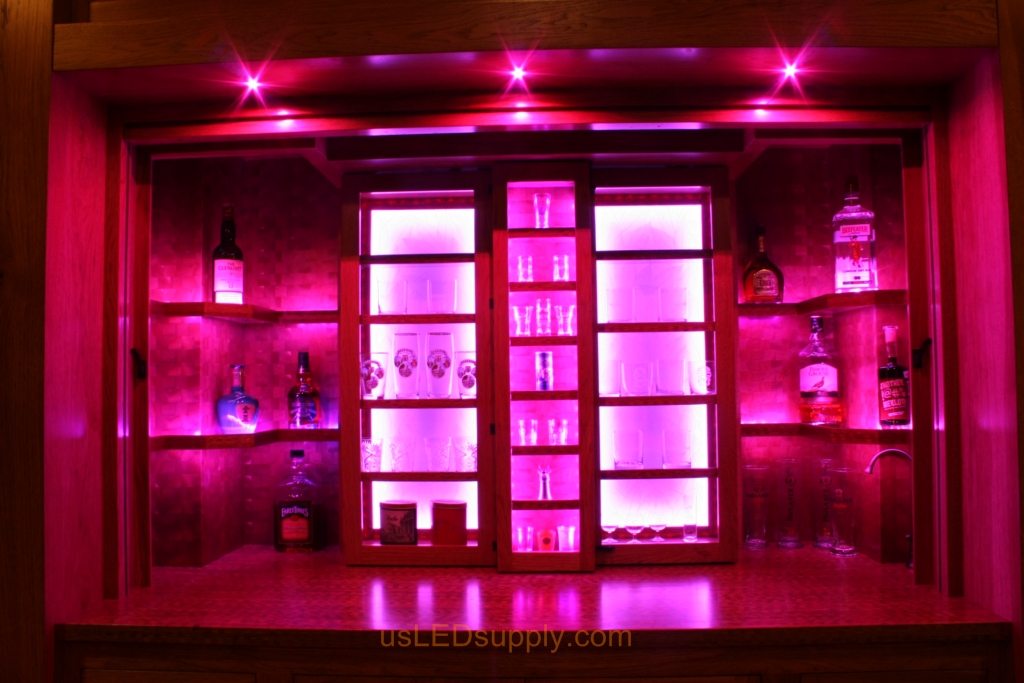 RGB LED Strips in different zones create color effects on this home bar shelving.
