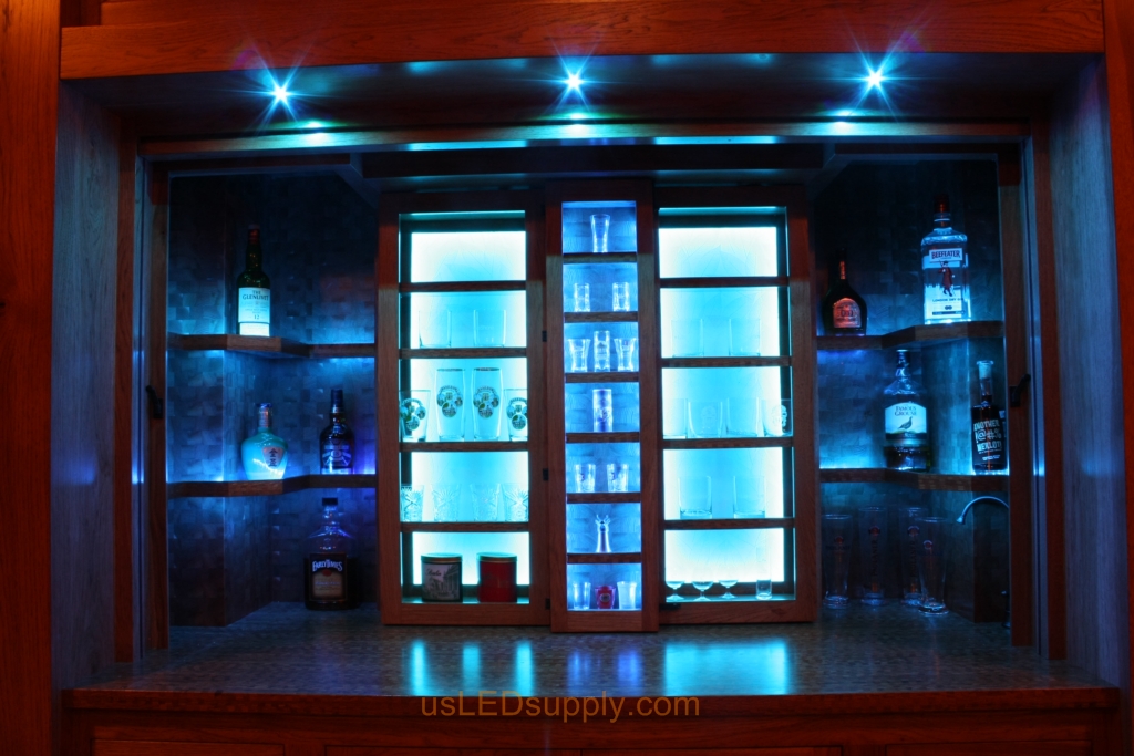 RGB LED Strips in different zones create color effects on this home bar shelving.