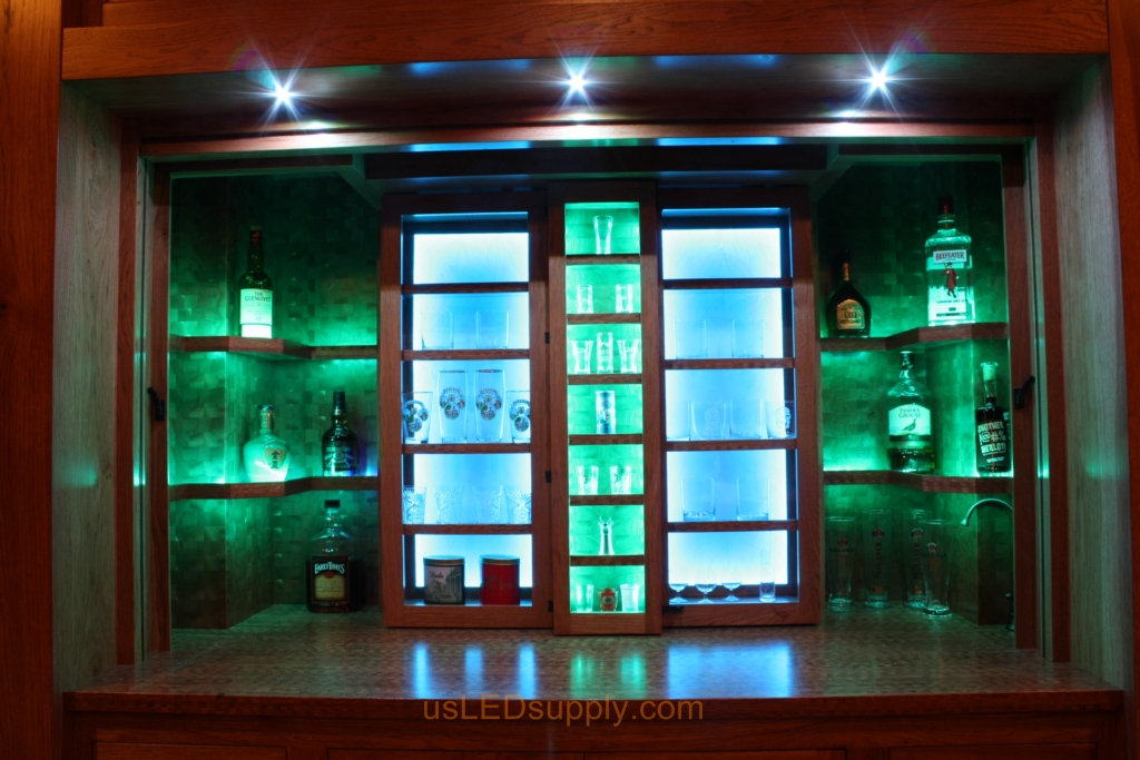 RGB LED Strips in different zones create color effects on this home bar shelving.