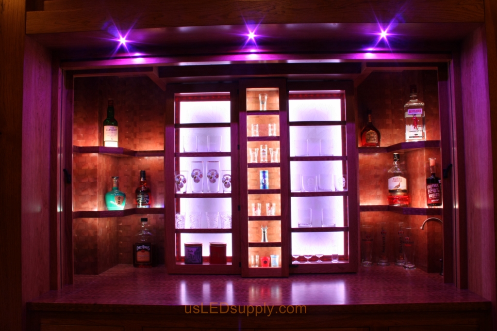 RGB LED Strips in different zones create color effects on this home bar shelving.