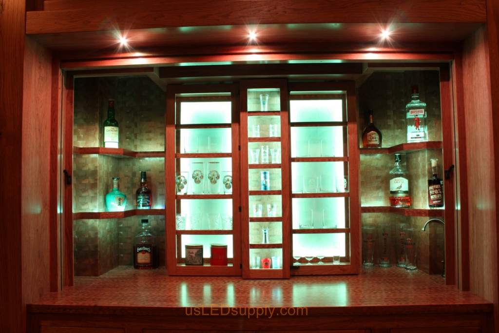 RGB LED Strips in different zones create color effects on this home bar shelving.