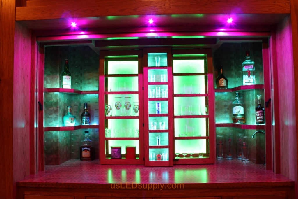 RGB LED Strips in different zones create color effects on this home bar shelving.