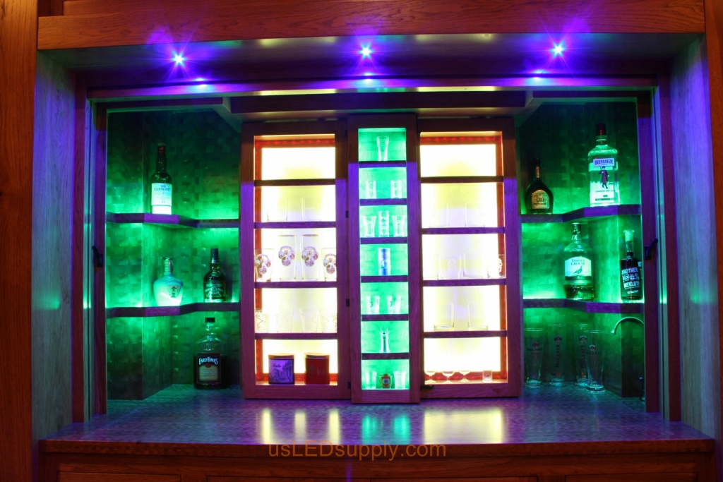 RGB LED Strips in different zones create color effects on this home bar shelving.