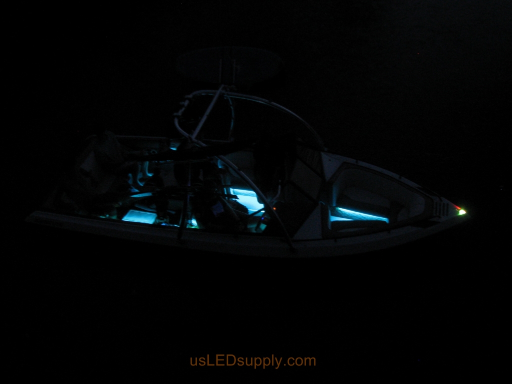 Malibu Sunsetter Boat on the water at night with RGB color changing LEDs lighting up the interior.
