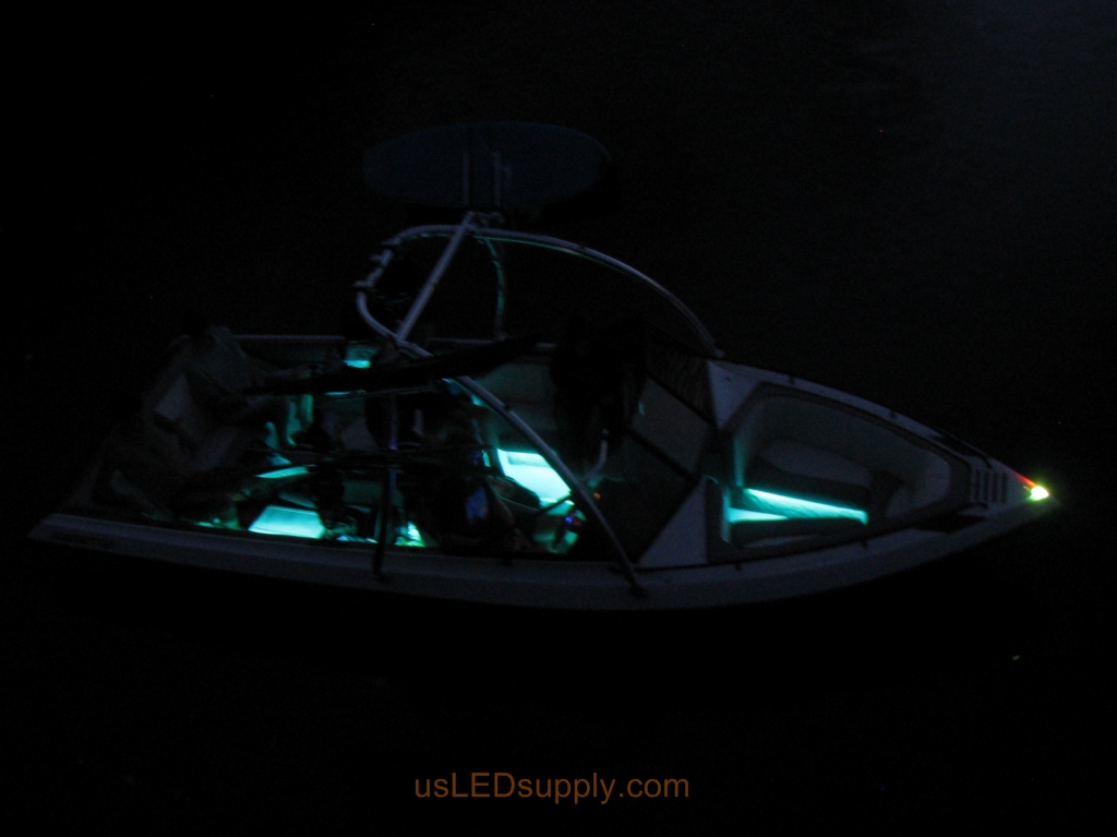 Malibu Sunsetter Boat on the water at night with RGB color changing LEDs lighting up the interior.