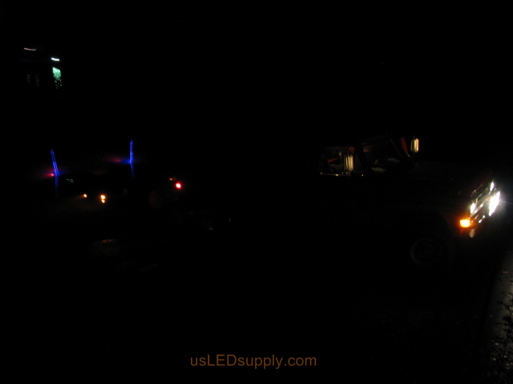 Malibu boat approaches the blue LED lit pylons to load onto the trailer.