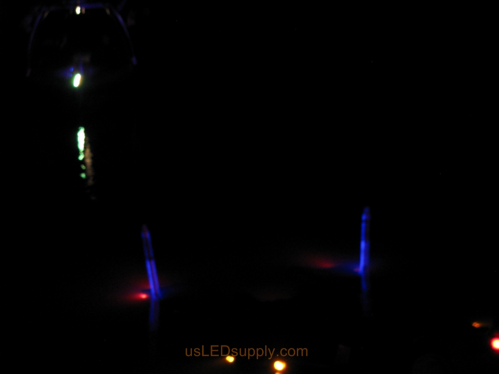 Malibu boat approaches the blue LED lit pylons to load onto the trailer.