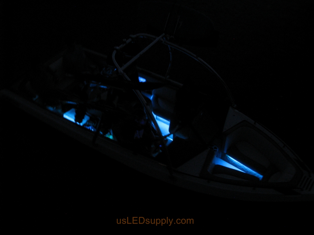 Malibu Sunsetter on the water at night with RGB color changing LEDs lighting up the interior.