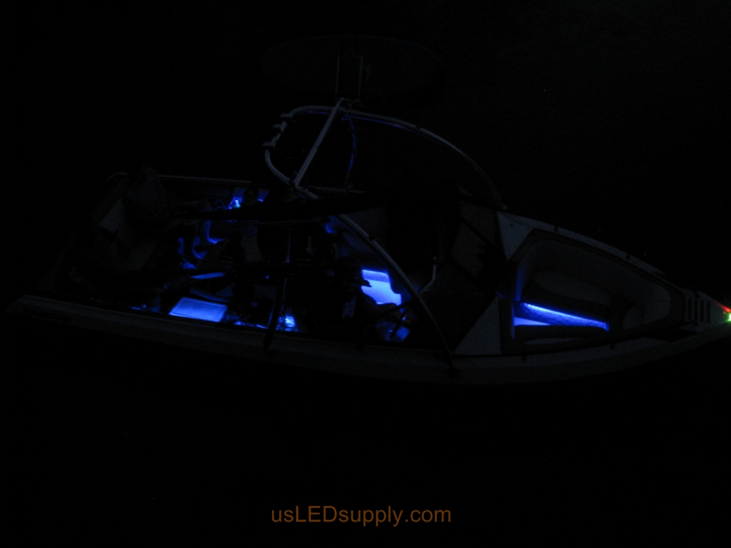 Malibu Sunsetter Boat on the water at night with RGB color changing LEDs lighting up the interior.