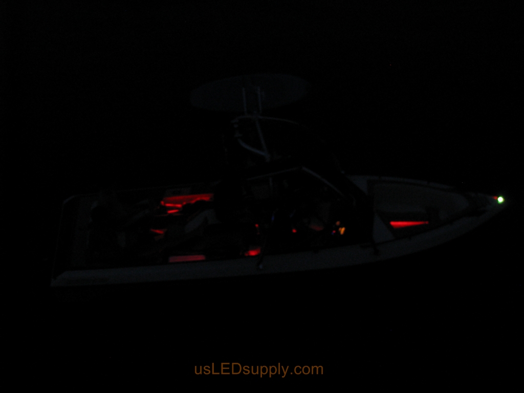 Malibu Sunsetter Boat on the water at night with RGB color changing LEDs lighting up the interior.