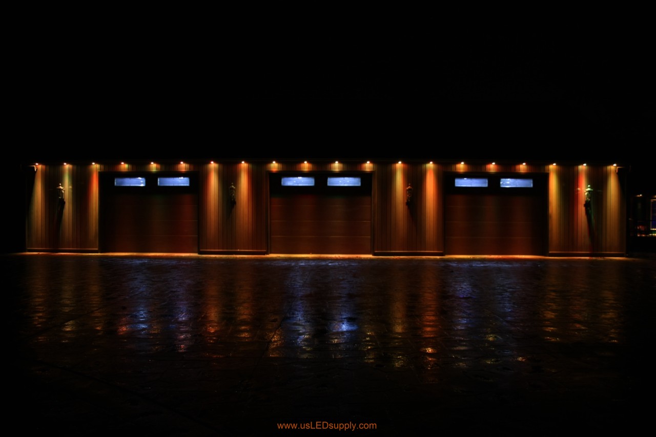 RGB Puck Lights outside of a garage set on light orange.