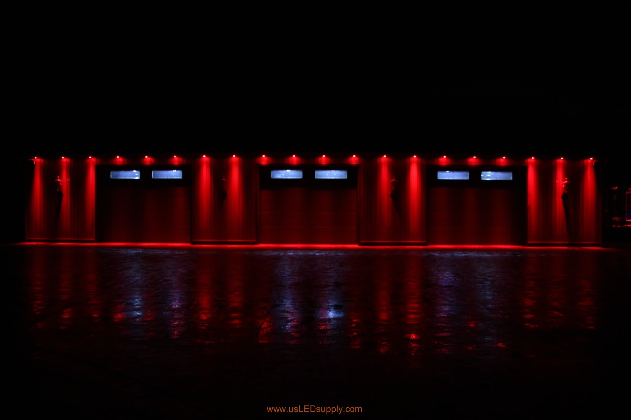 RGB Puck Lights outside of a garage set on red color.