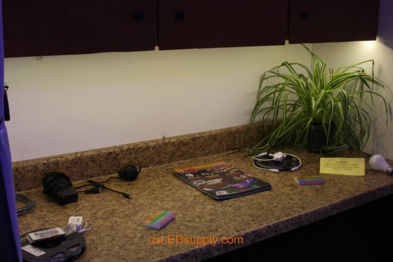 Undercabinet LED lighting example in trade show booth using 12V warm white flexible LED strips.