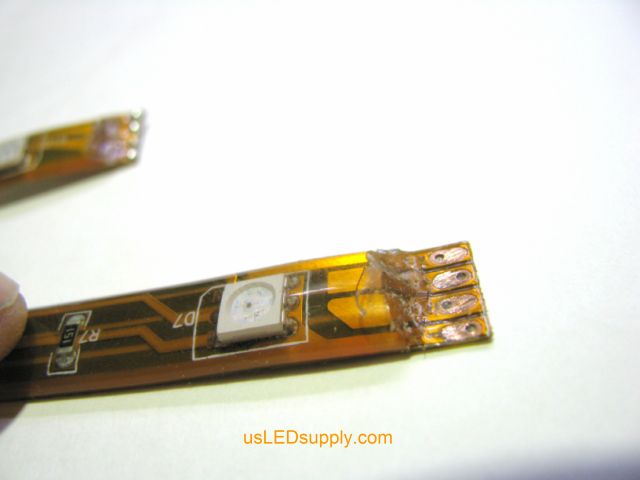 End of RGB flexible LED strip waterproof coating peeled and cleaned