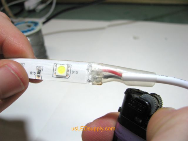Cover solder connection with heat shrink tubing
