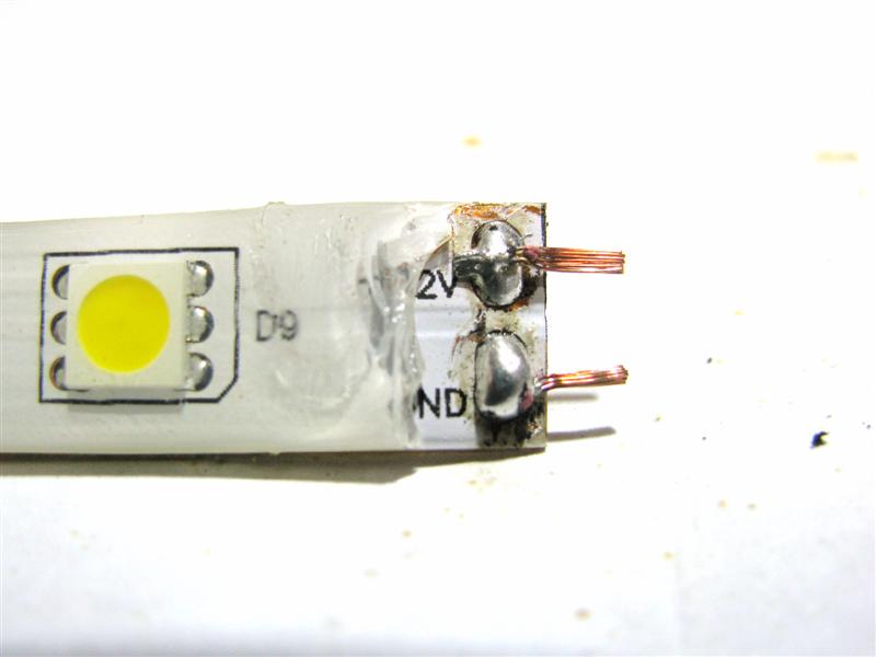 Stripped wires attached to the end of single color flexible LED strip.