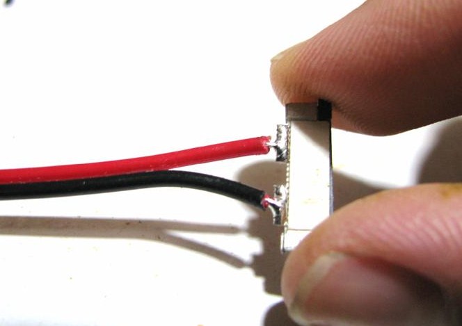 Pulling out black piece of single color splice connector to open it