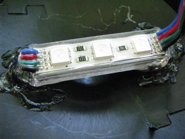 RGB LED module attached to the light cap with hot glue.