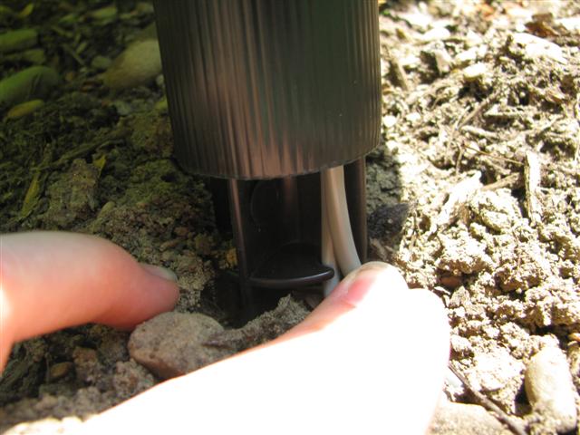 Slide the light poll over the stake top, making sure that the wires are in the appropriate channel.