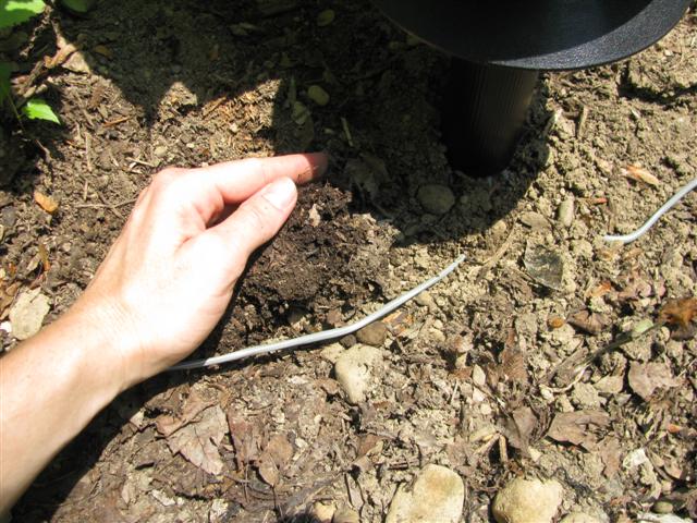Bury the control cable with your hands or a shovel if the ground is hard.