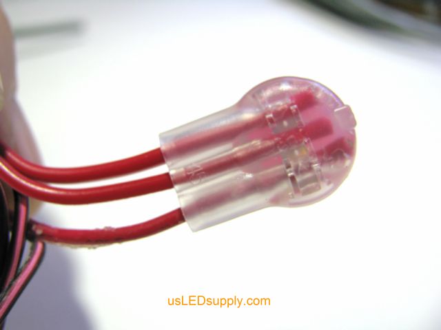 Three red wires inserted fully into a 3M butt (crimp) connector