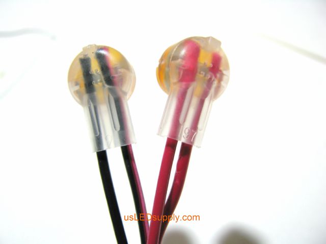 Red and black wires fully inserted into crimped butt connectors